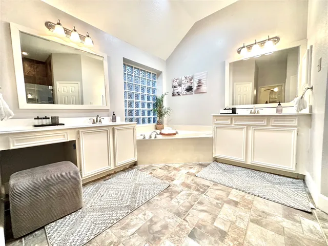 a bathroom with a bathtub and shower