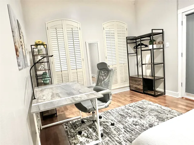 a bedroom with a bed and wooden floor