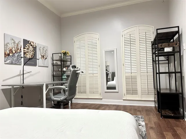 a bedroom with a bed and a night stand