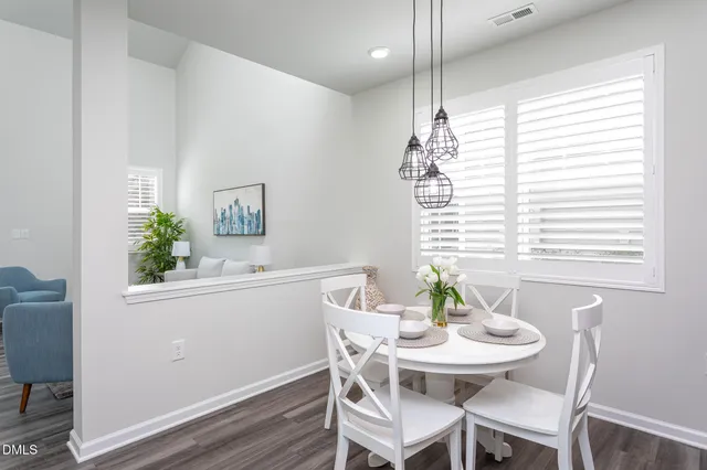 a kitchen with stainless steel appliances granite countertop white cabinets sink and white appliances