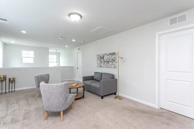 a living room with furniture a rug and a window