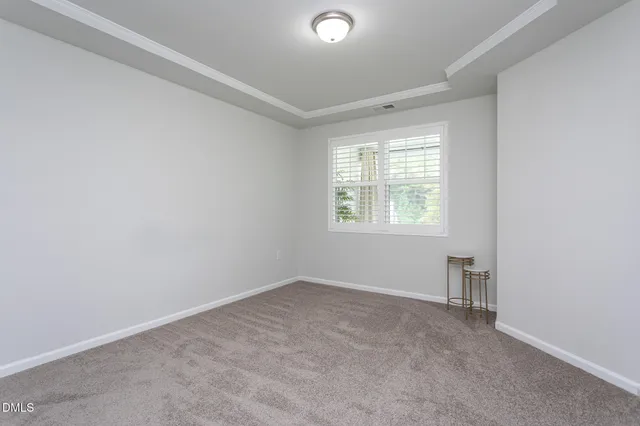 a living room with furniture a window and a potted plant
