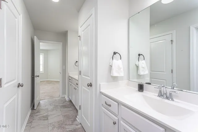 a bathroom with a double vanity sink and a mirror