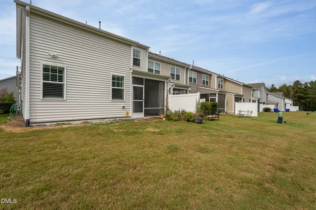 a view of a house with a yard and sitting space
