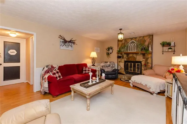 a living room with furniture a flat screen tv and a window