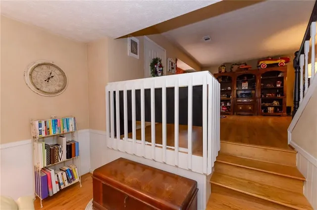 a bedroom with a bed dresser and cabinets