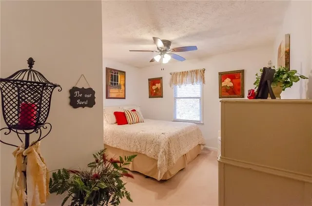 a bed sitting in a bedroom next to a window