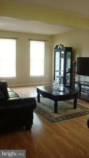 17567 Deweys Run Lane Dumfries, VA 22026 - Photo 12 of 20 a living room with a couch and a flat screen tv