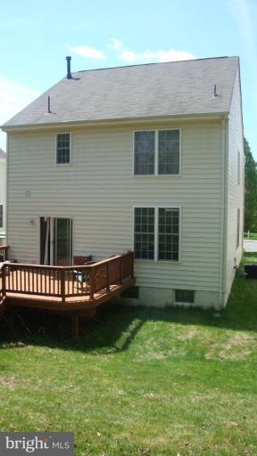 17567 Deweys Run Lane Dumfries, VA 22026 - Photo 16 of 20 a front view of a house with a yard