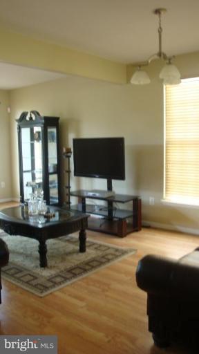 17567 Deweys Run Lane Dumfries, VA 22026 - Photo 3 of 20 a living room with furniture and a flat screen tv