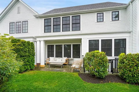 a view of a house with a backyard and sitting area