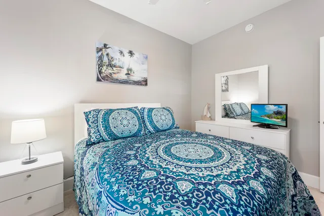 a living room with furniture a couch and a potted plant