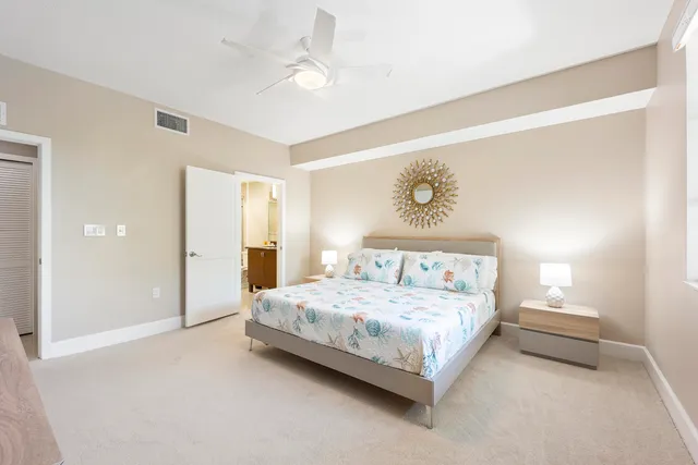 a bedroom with a bed and a painting on the wall