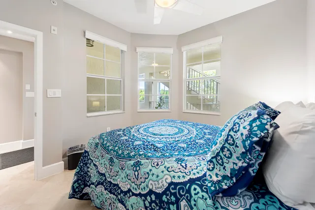 a bed sitting in a bedroom next to a window