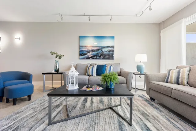 a living room with furniture and a potted plant