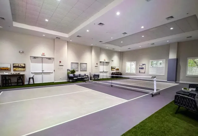 a view of a kitchen with kitchen island stainless steel appliances a sink and counter top