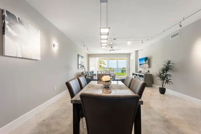 a dining room with furniture a chandelier and window