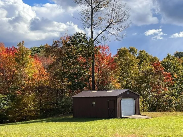a view of a swimming pool with a patio and a yard
