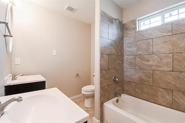 a bathroom with a sink and mirror with toilet
