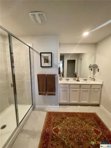 a bathroom with a sink a mirror and a bath tub