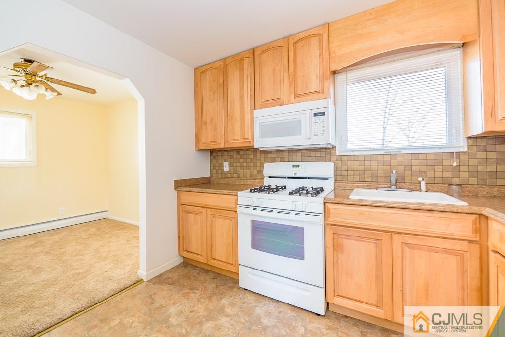 21 Baldwin Road Edison, NJ 08817 - Photo 8 of 25 a kitchen with a stove a sink and a window