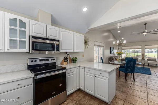 a kitchen with cabinets appliances and a counter top space