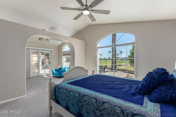 a bedroom with a large bed and a large window