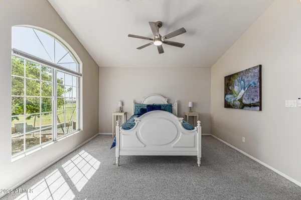 a bedroom with a bed and a large window