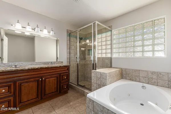 a bathroom with a tub a sink and mirror