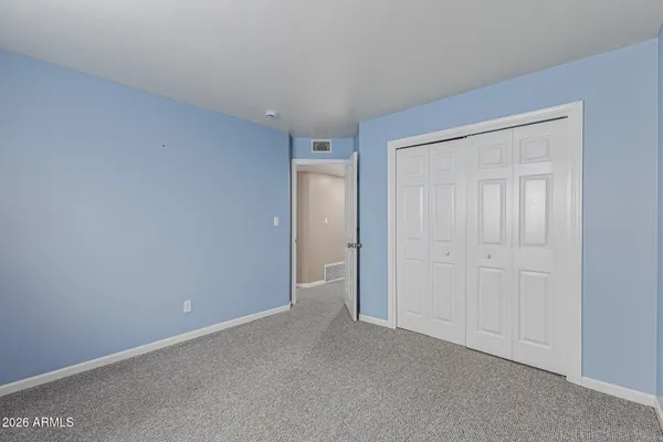 a view of an empty room and closet area