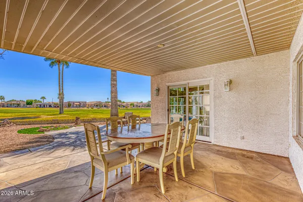 a view of a swimming pool and outdoor seating
