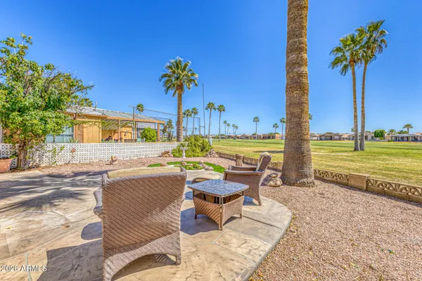 a view of a swimming pool and lounge chairs