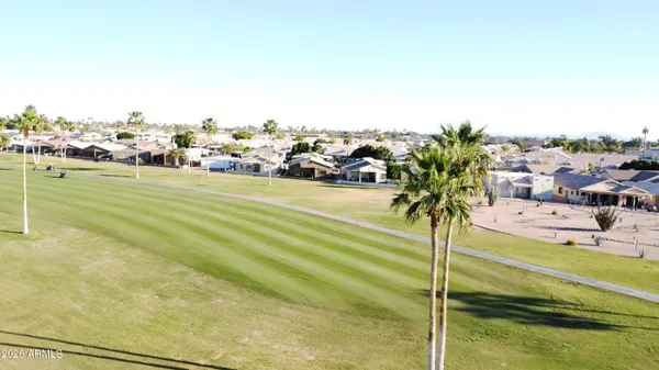 a view of a swimming pool with a lawn chairs