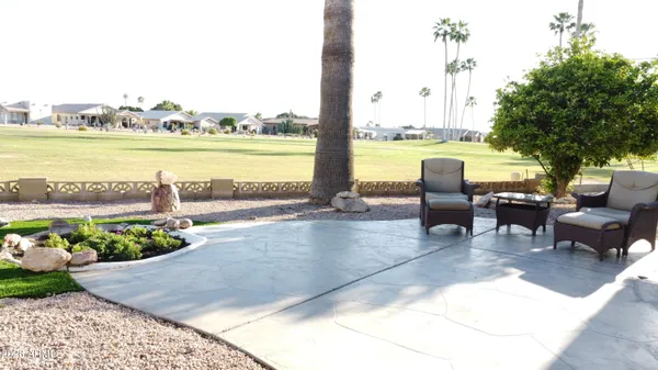 a view of swimming pool with outdoor seating and a garden