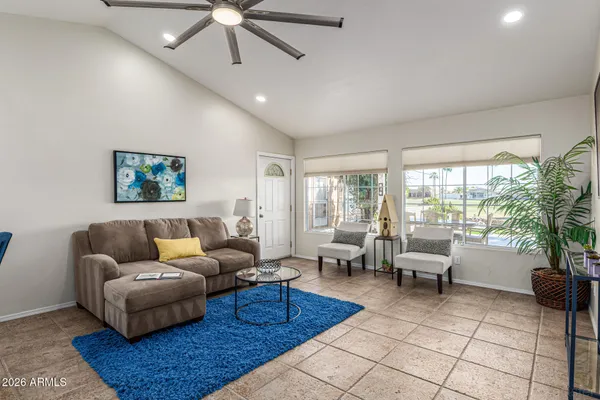a living room with furniture and a potted plant