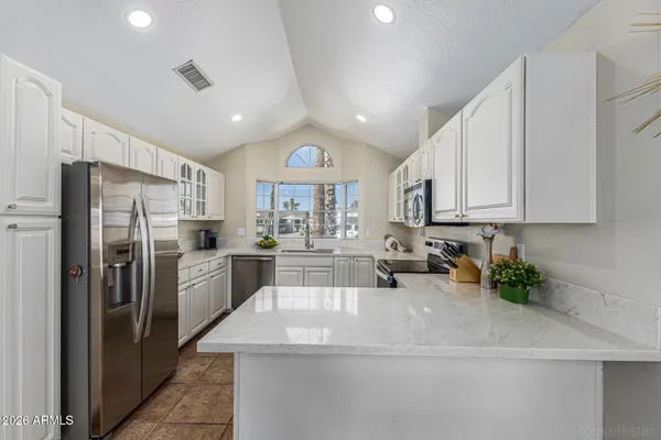 a kitchen with refrigerator and cabinets