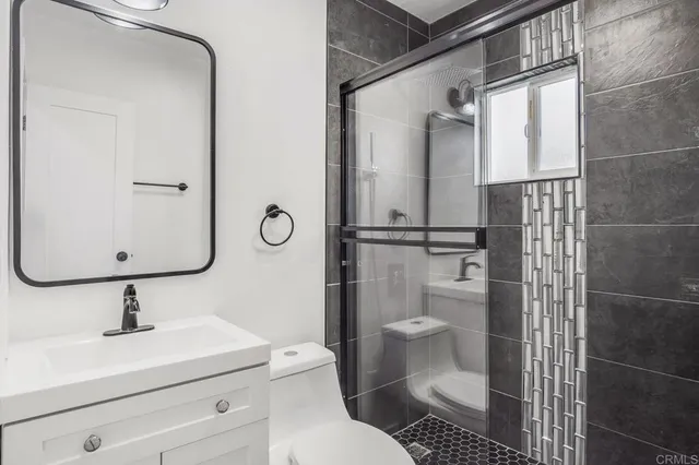 a bathroom with a toilet sink and shower