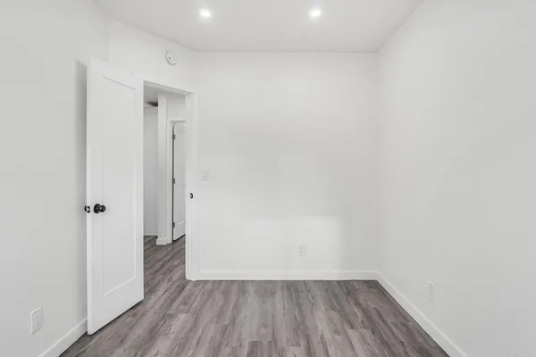 a view of a room with wooden floor