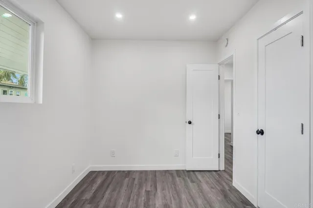 a view of room with wooden floor