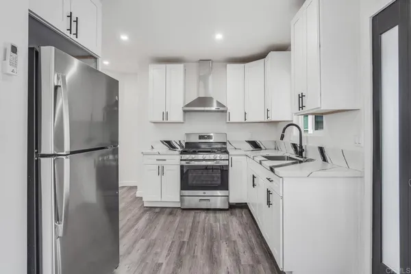 a kitchen with a refrigerator sink and stove