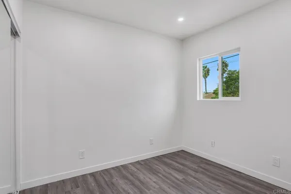 a view of room with wooden floor and fan