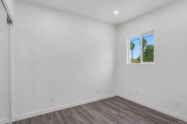 a view of room with wooden floor and fan