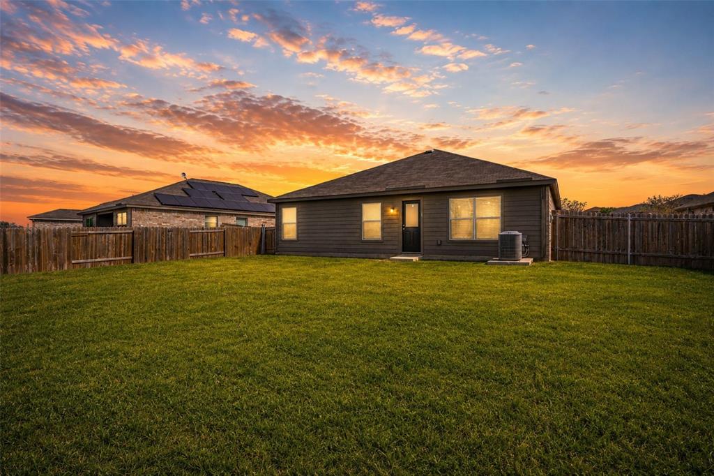 144 Barbwire Way Newark, TX 76071 - Photo 26 of 32 a front view of a house with a garden