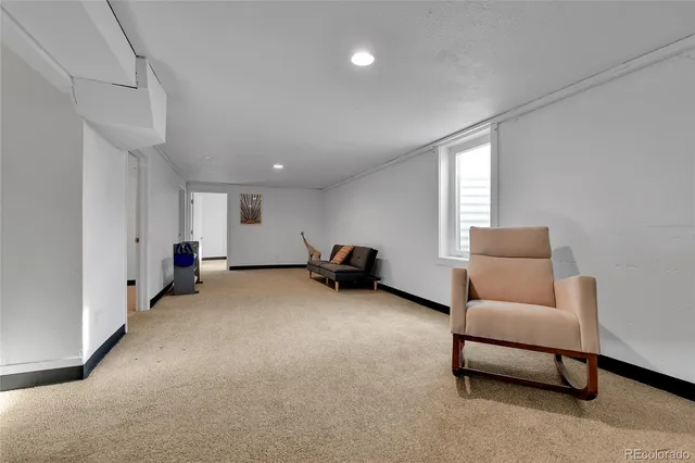 a living room with furniture and a lamp