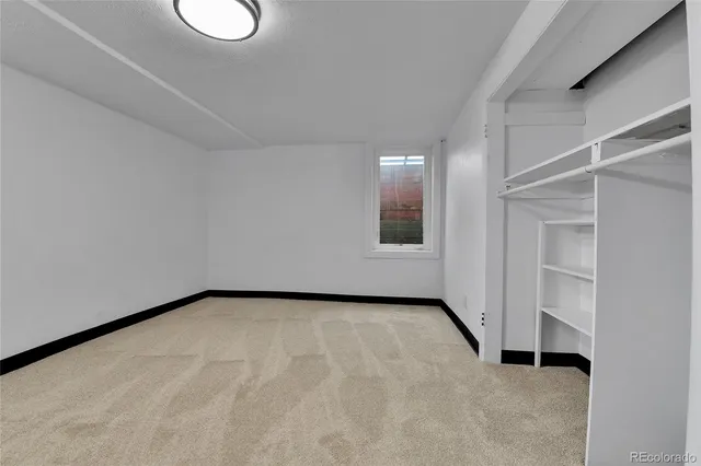 a view of a room with wooden floor and bathroom