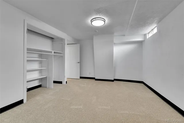 a view of an empty room and a ceiling fan