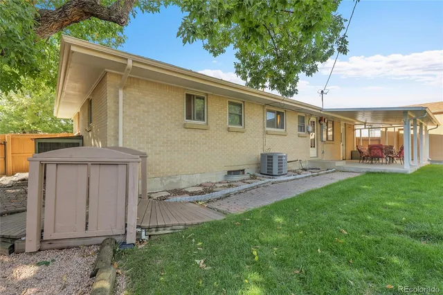 a backyard of a house with table and chairs