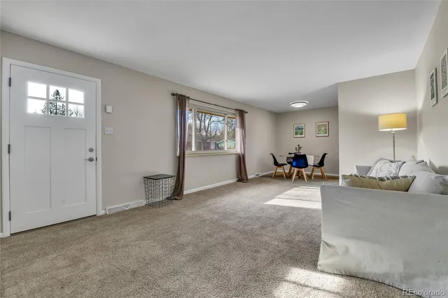 a view of a livingroom with window and furniture
