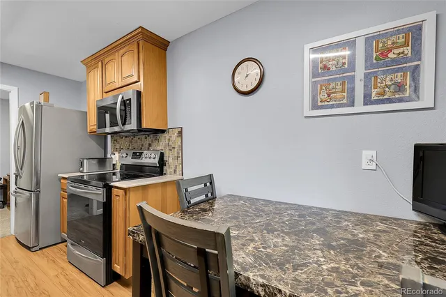 a kitchen with stainless steel appliances a stove a refrigerator and a refrigerator