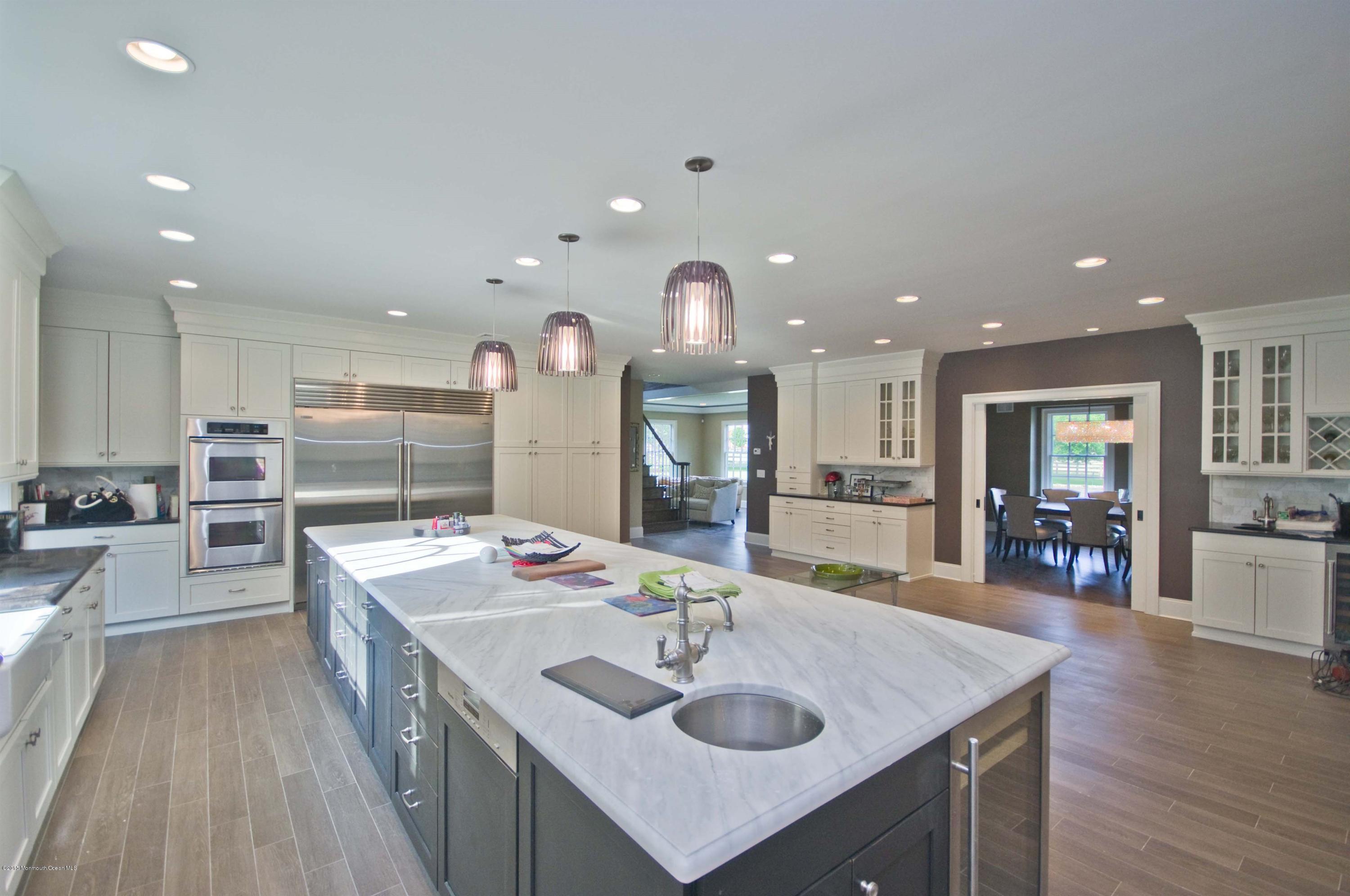 51 Phalanx Road Colts Neck, NJ 07722 - Photo 11 of 35 a kitchen with counter top space sink stove and wooden floor